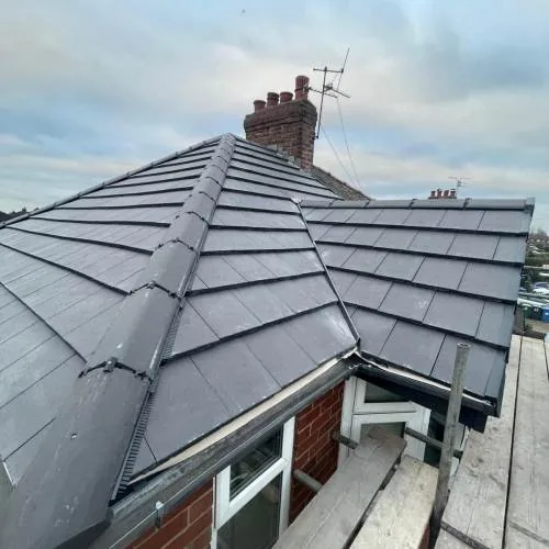 Grey tiled roof with scaffolding still in place
