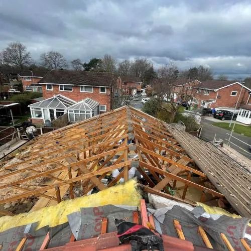 Old roof covering stripped back to the rafters ready for re-roofing