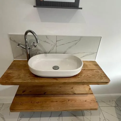 Rustic wooden vanity shelf with countertop basin